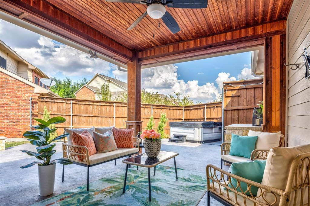 10138 Planters Row Drive, Frisco, TX 75033 A wood-plank ceiling and ceiling fan keep the covered patio comfortable, with plenty of room to stretch out in the shade.