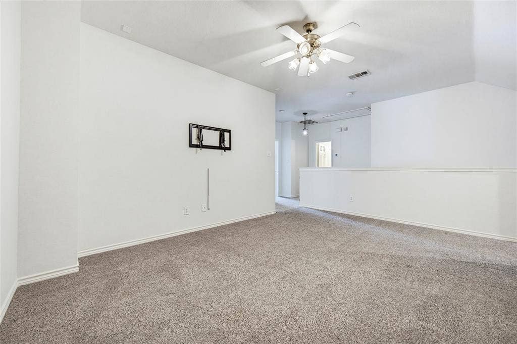 10138 Planters Row Drive, Frisco, TX 75033 A spacious upstairs game room with a ceiling fan and TV wiring, ready for movie nights and playoff Saturdays.