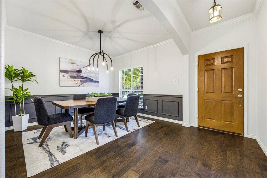 10138 Planters Row Drive, Frisco, TX 75033 Stylish black wainscoting and rich hardwood floors make a sharp first impression right off the entry, setting the stage for dinners and hosting.