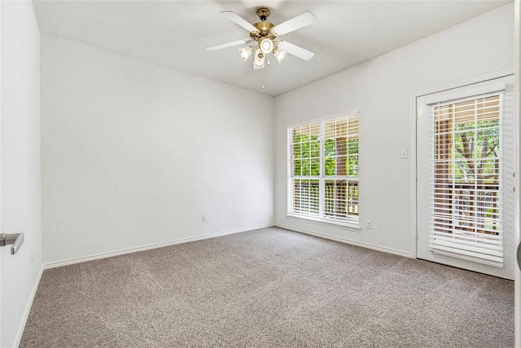 10138 Planters Row Drive, Frisco, TX 75033 Recent carpet, a ceiling fan, and natural light, and this bedroom opens to its own private covered balcony.