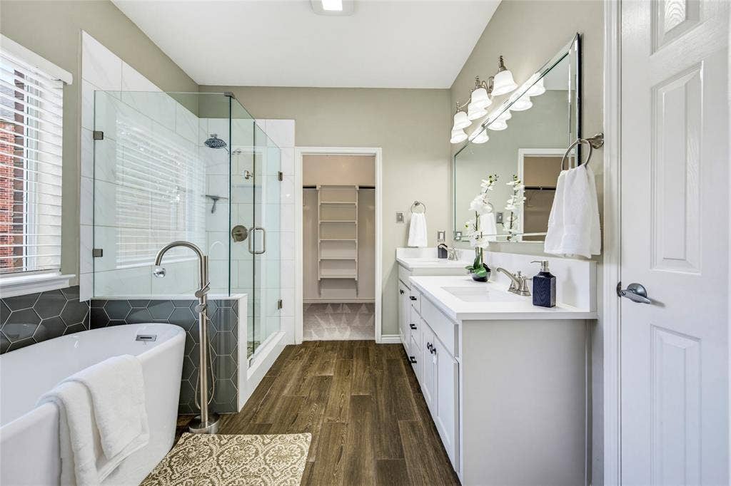 10138 Planters Row Drive, Frisco, TX 75033 A free-standing soaking tub, frameless glass shower, and walk-in closet turn the everyday routine into a spa-worthy moment.