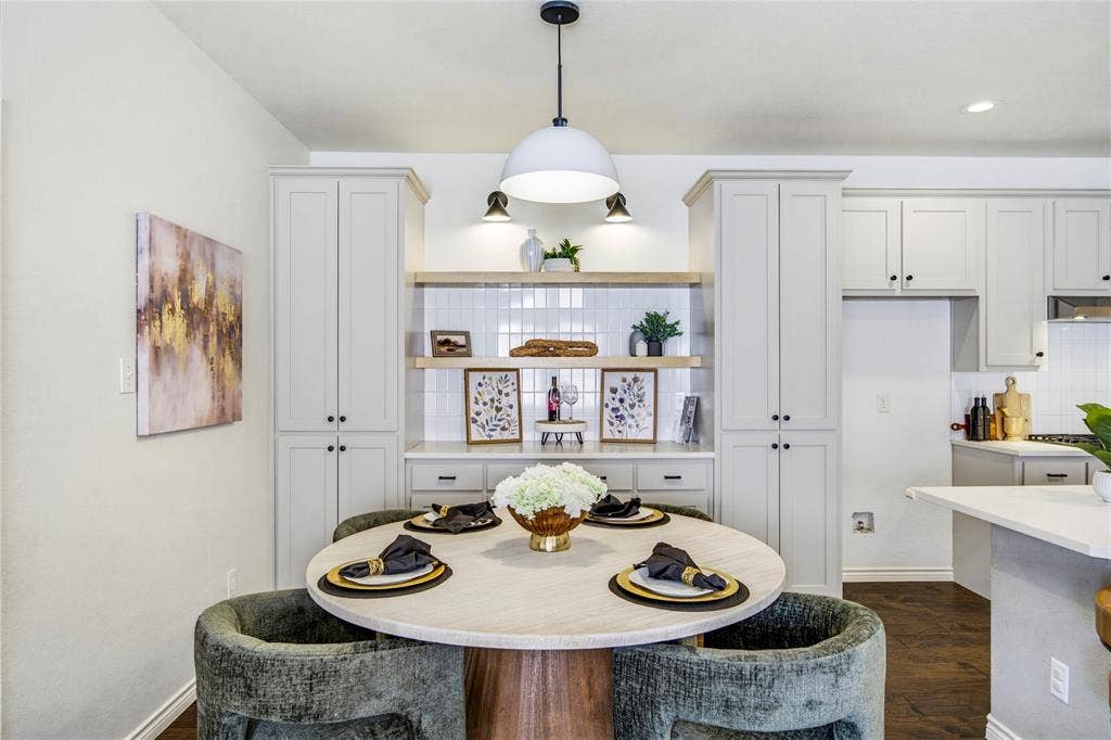 10138 Planters Row Drive, Frisco, TX 75033 A sunny breakfast nook framed by white cabinetry and a modern pendant, set between the kitchen and living room for easy everyday flow.