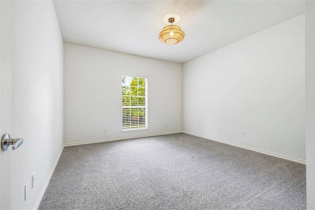10138 Planters Row Drive, Frisco, TX 75033 Bright and neutral with recent carpet, ready to serve as a bedroom, guest room, hobby space, or home gym.