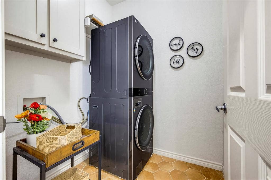 10138 Planters Row Drive, Frisco, TX 75033 A functional utility room with shelving and storage, and the versatile stackable or side by side washer and dryer convey.