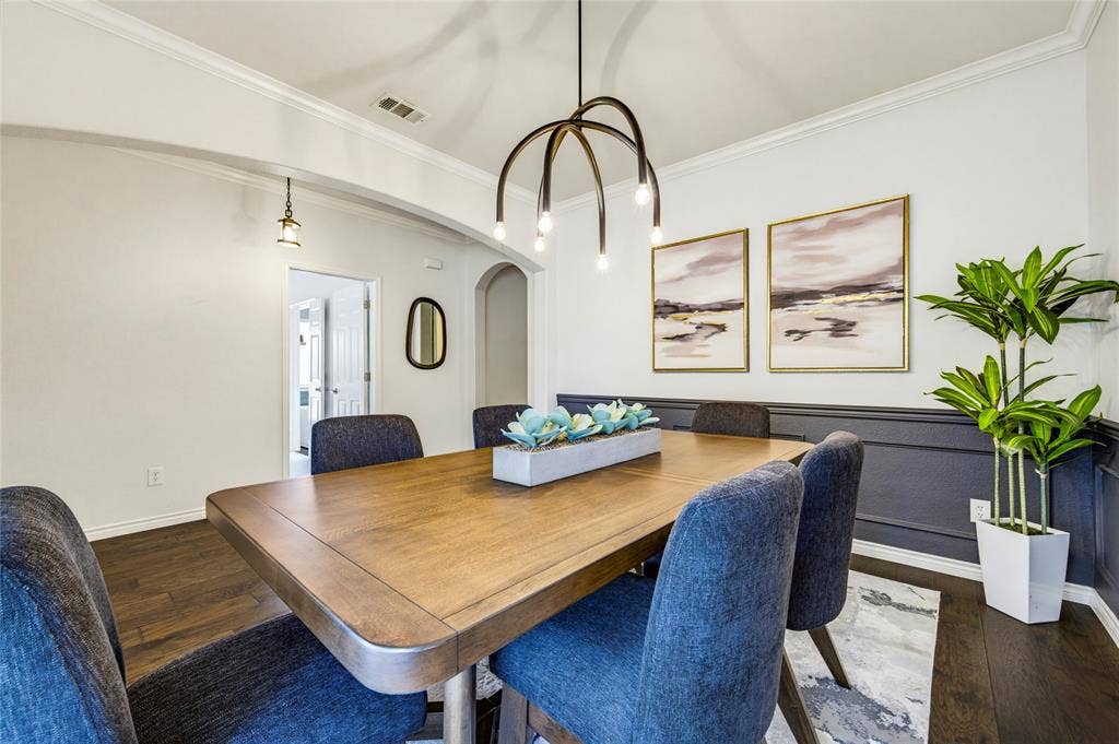 10138 Planters Row Drive, Frisco, TX 75033 A statement chandelier and dramatic two-tone walls give the formal dining room real personality. Dinner parties just got an upgrade.