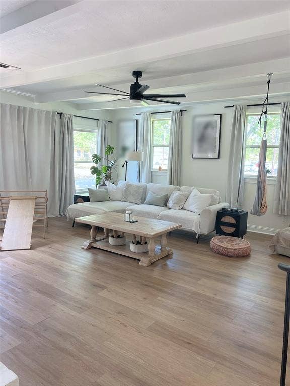 1200 Daisy Lane, Irving, TX 75061 Wood-finish flooring throughout, complemented by a contemporary black ceiling fan and crisp white ceiling beams