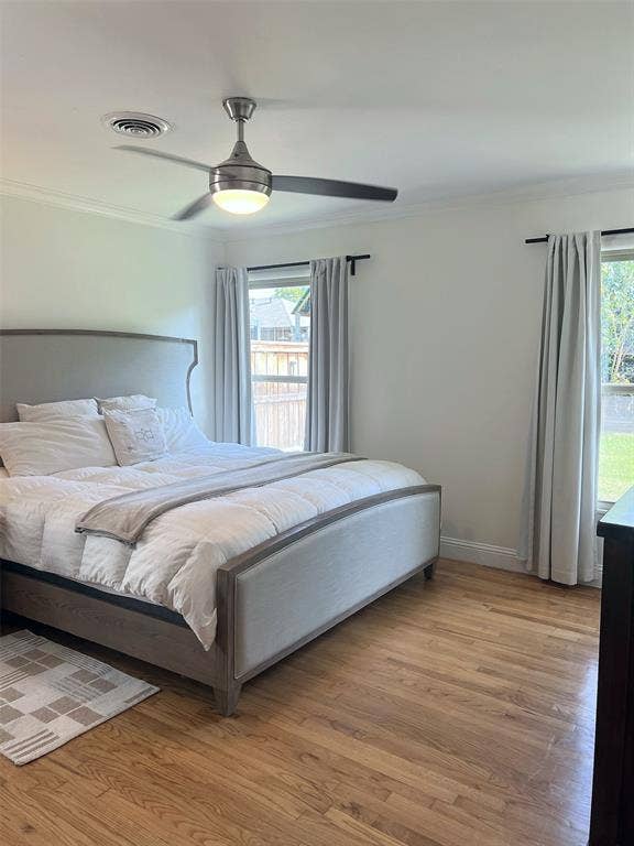 1200 Daisy Lane, Irving, TX 75061 Hardwood flooring, crown molding, dual windows, and ceiling fan with integrated lighting