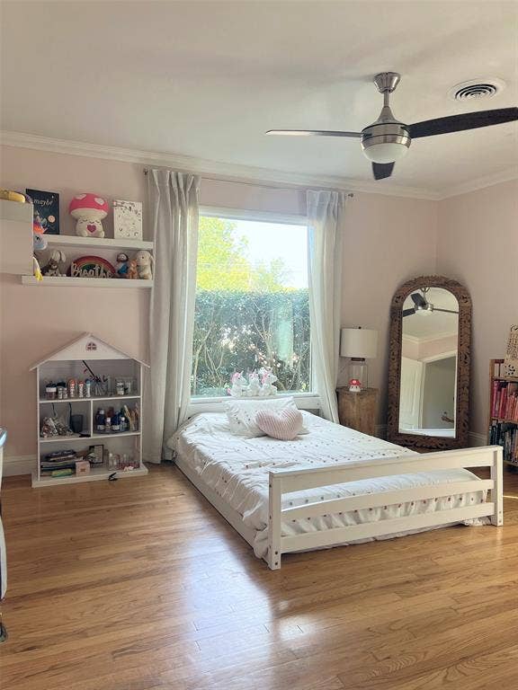 1200 Daisy Lane, Irving, TX 75061 Hardwood flooring, large window with drapes, crown molding, and a ceiling fan with integrated lighting
