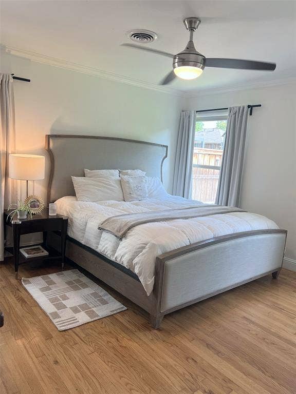 1200 Daisy Lane, Irving, TX 75061 Hardwood flooring, crown molding, and a ceiling fan with integrated lighting
