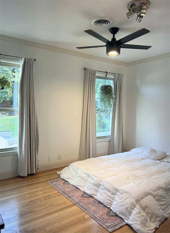 1200 Daisy Lane, Irving, TX 75061 Hardwood flooring, crown molding, dual windows, and ceiling fan with integrated lighting
