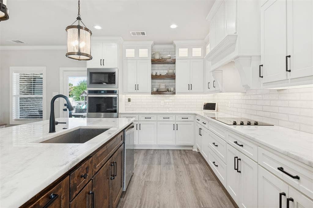 108 Rye Place, Gun Barrel City, TX 75156 Kitchen featuring white cabinetry, subway tile backsplash, white countertops, built-in stainless steel appliances, and a wood-finish flooring