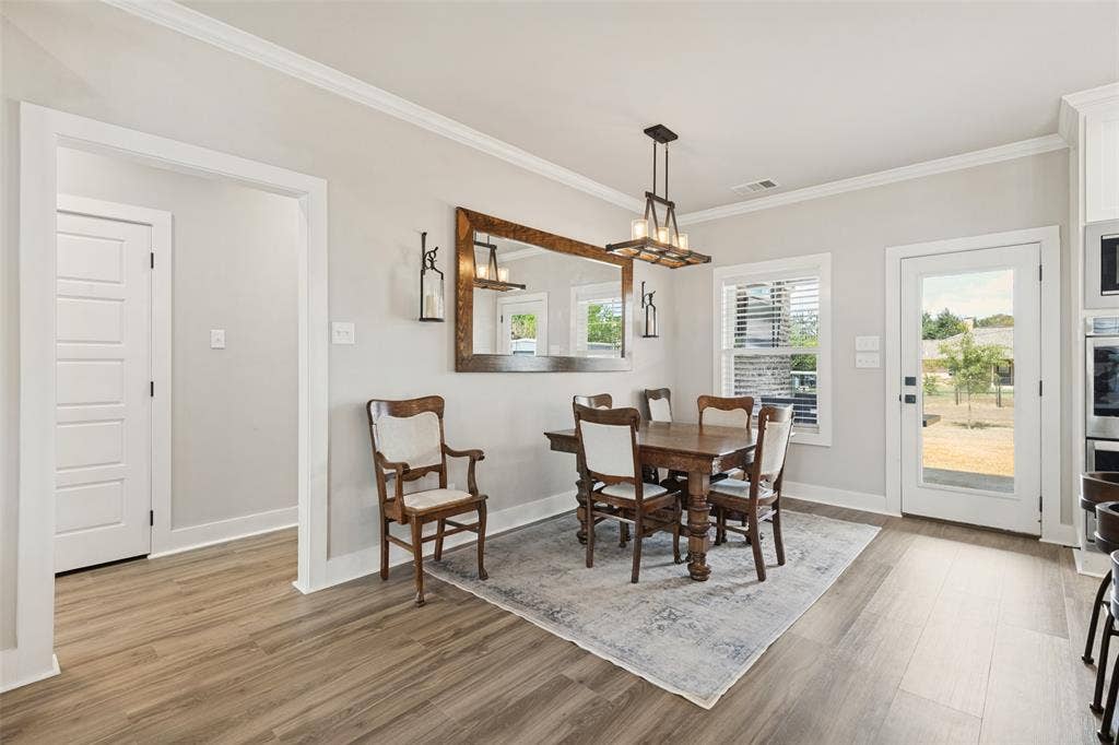 108 Rye Place, Gun Barrel City, TX 75156 Wood-finish flooring, crown molding, white paneled interior doors, and a glass-paneled exterior door