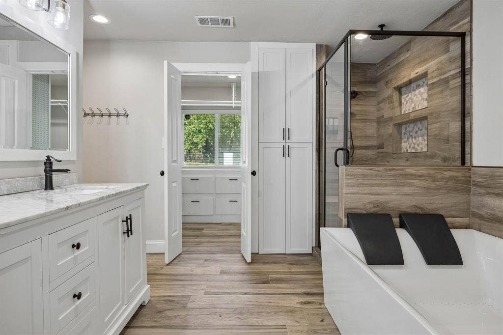 Dual sinks, soaking tub for two with a TV, separate shower and water closet.