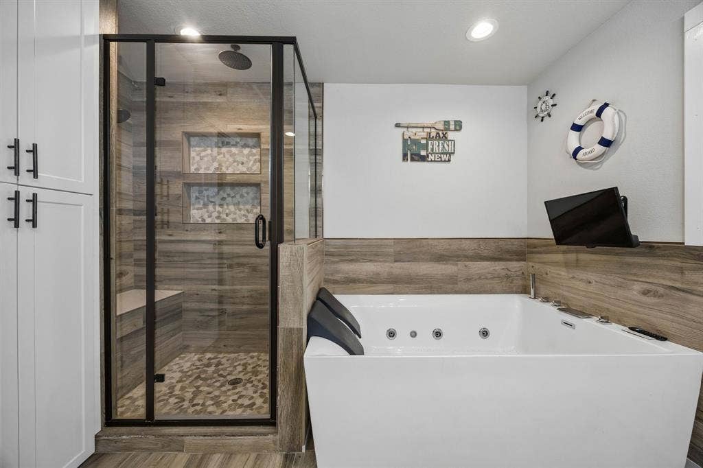 Dual sinks, soaking tub for two with a TV, separate shower and water closet.