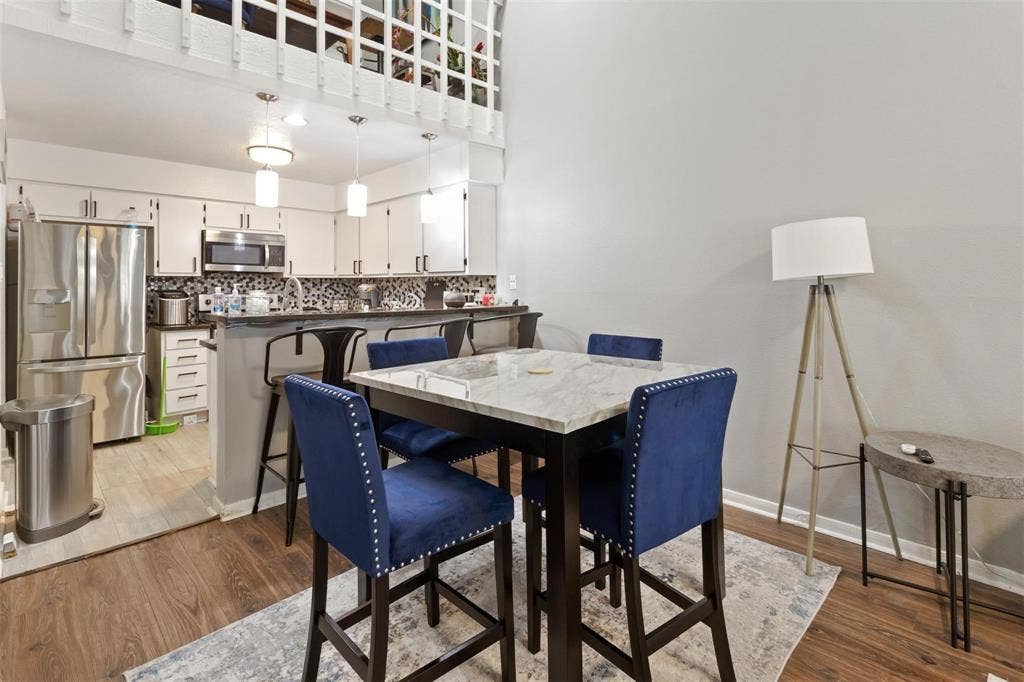 13026 Leader Street, #951, Houston, TX 77072 Kitchen with stainless steel appliances, white cabinetry, dark countertops, and a patterned tile backsplash