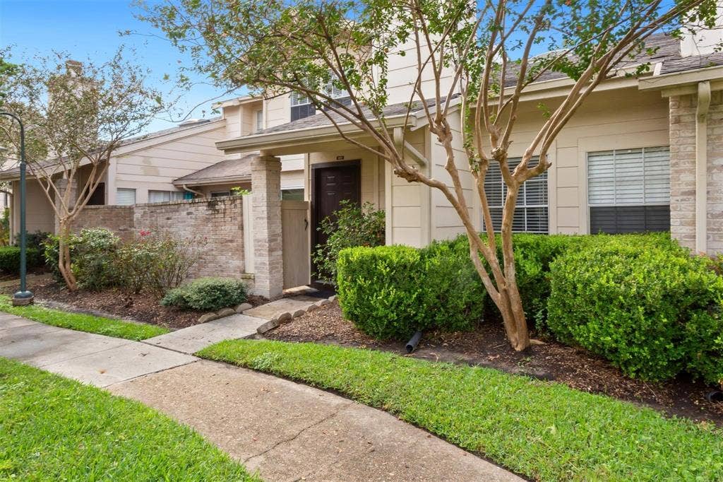 13026 Leader Street, #951, Houston, TX 77072 Exterior featuring brick and siding, established landscaping, and a concrete walkway