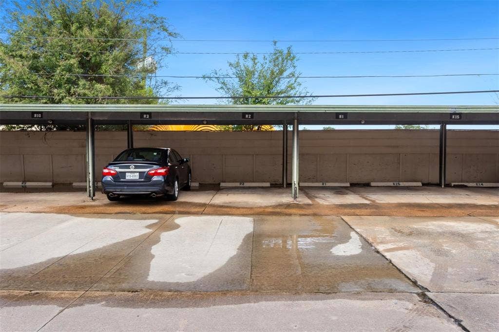13026 Leader Street, #951, Houston, TX 77072 Covered parking structure with multiple designated spaces and a concrete surface