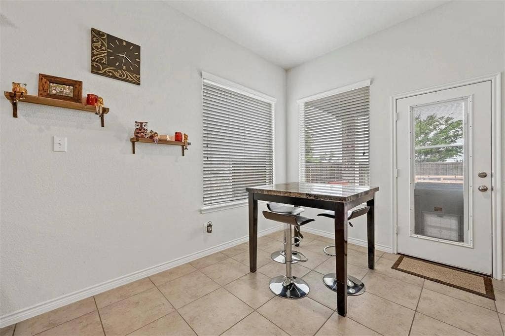 602 Brock Drive, Anna, TX 75409 Tile flooring, built-in shelving, multiple windows with blinds, and a glass-paneled exterior door