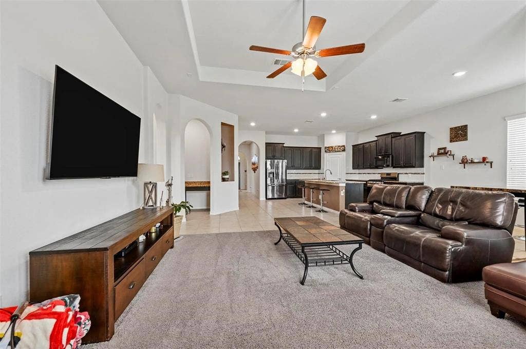 602 Brock Drive, Anna, TX 75409 Tray ceiling with a ceiling fan, recessed lighting, arched doorways, and tile flooring