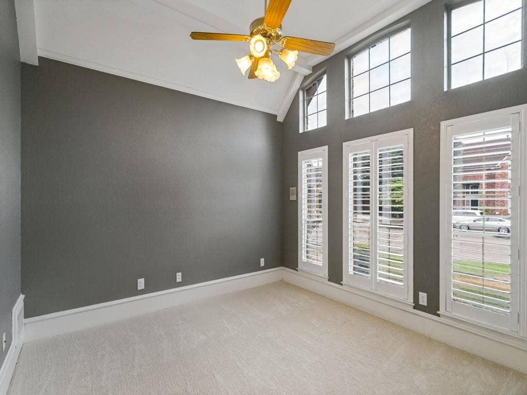 3309 Wolfe Court, Plano, TX 75025 Vaulted ceiling with crown molding, ceiling fan, carpeted flooring, and plantation shutters