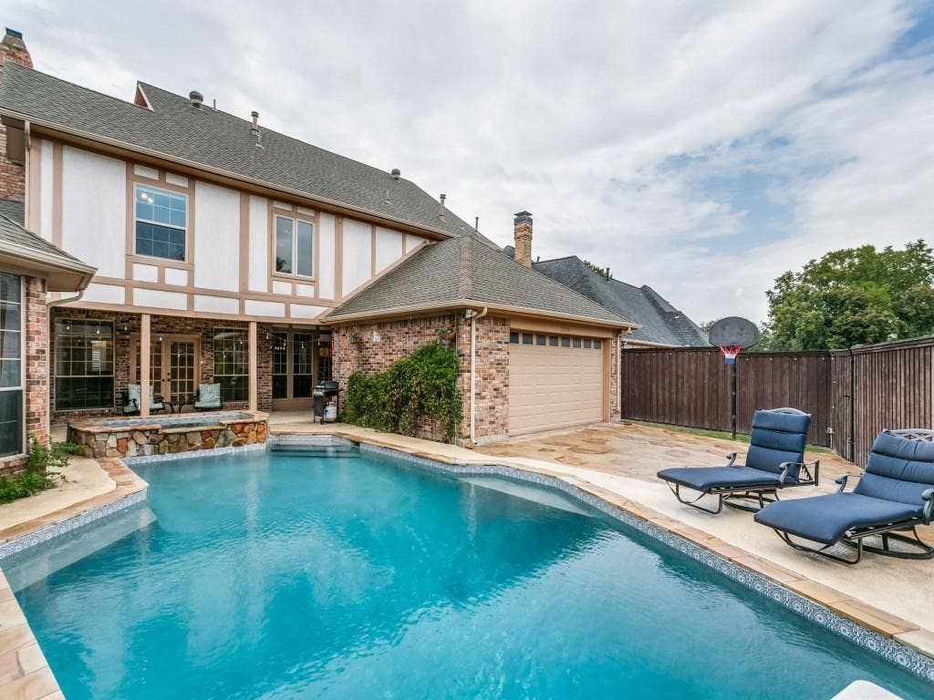 3309 Wolfe Court, Plano, TX 75025 Brick and half-timber exterior with a multi-level roofline