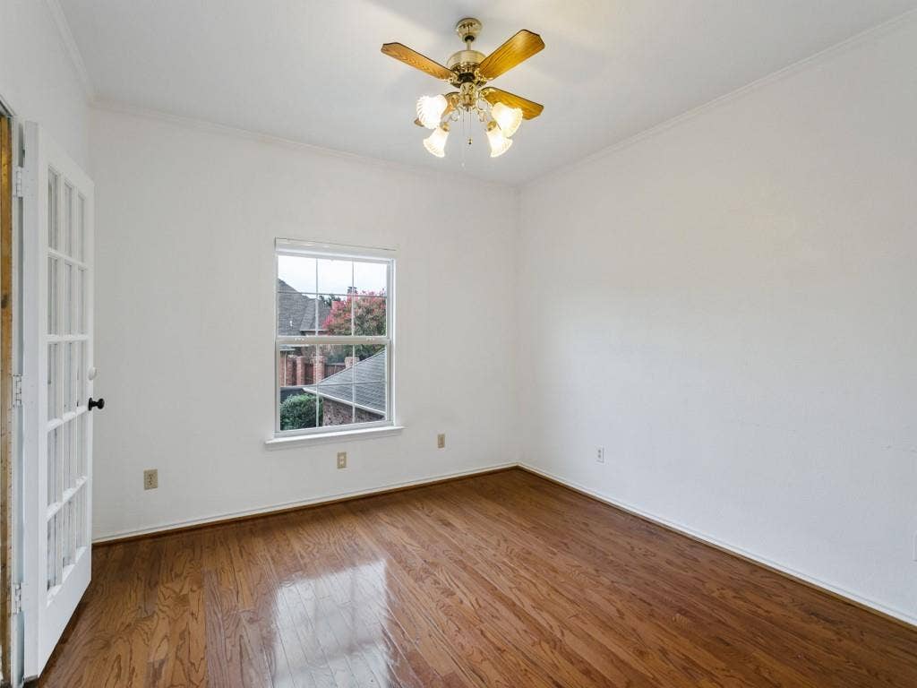3309 Wolfe Court, Plano, TX 75025 Hardwood flooring, white walls, single window, ceiling fan with integrated lighting, and French doors