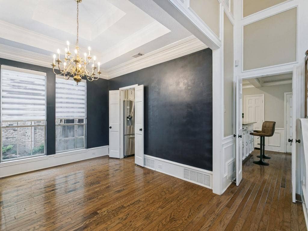 3309 Wolfe Court, Plano, TX 75025 Hardwood flooring, ornate chandelier, tray ceiling, extensive crown molding, and wainscoting