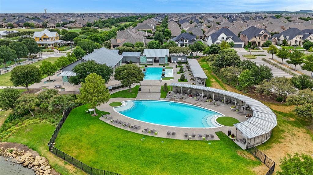 Community amenities featuring two swimming pools, shaded lounge areas, and surrounding green spaces