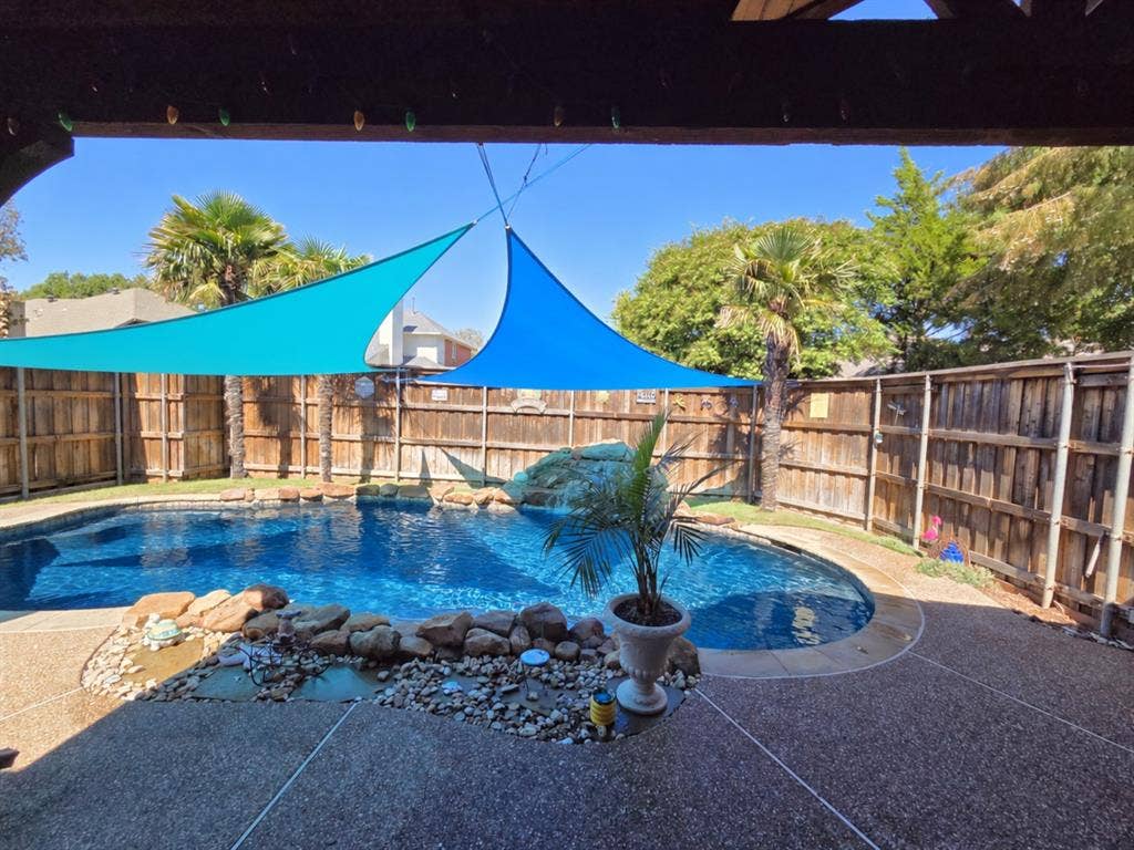 Swimming pool with rock features and water cascade