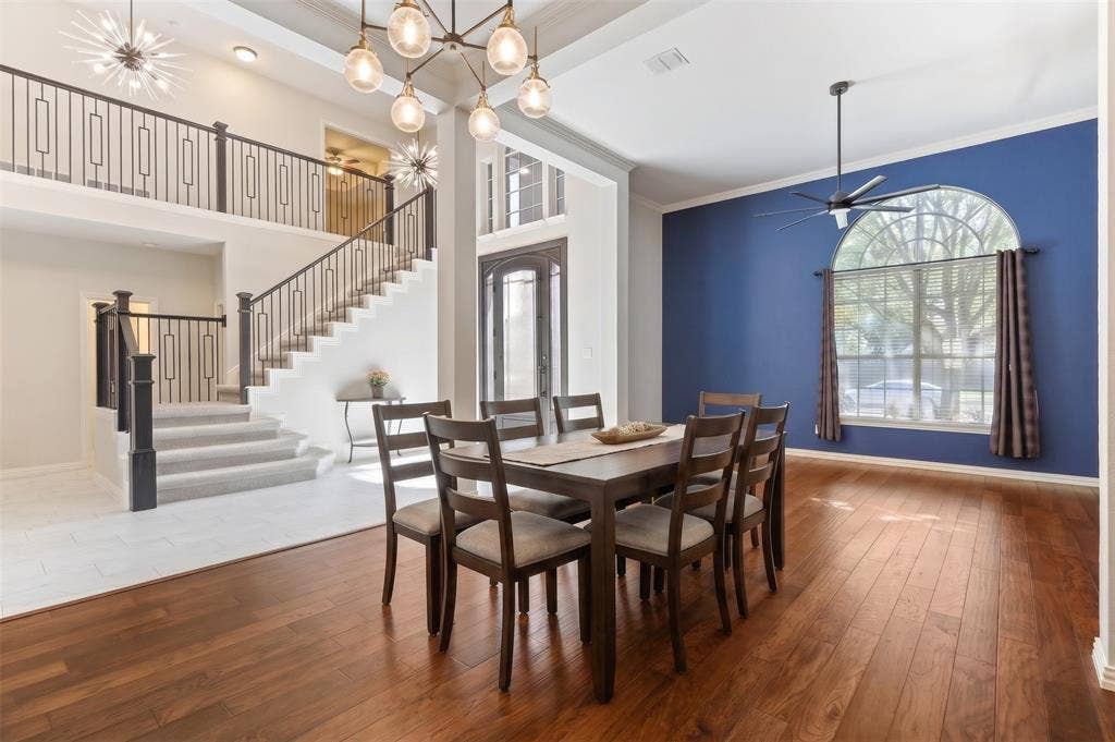 Open-concept ( virtually staged) dining area with wood flooring