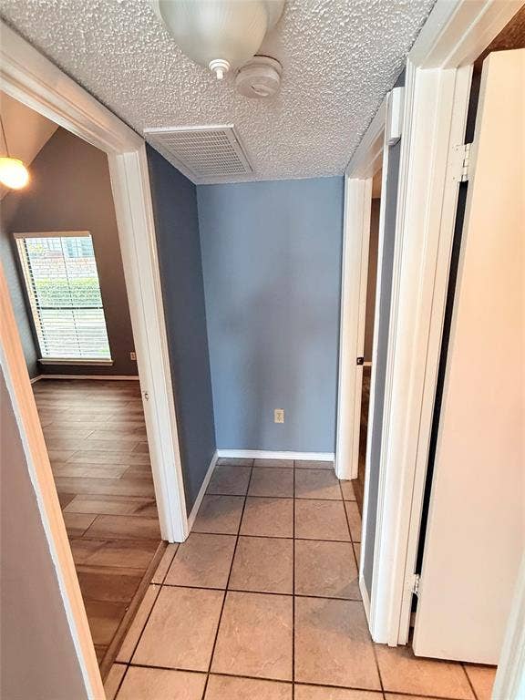 3402 Country Club Drive W, #154, Irving, TX 75038 Hallway featuring square tile flooring