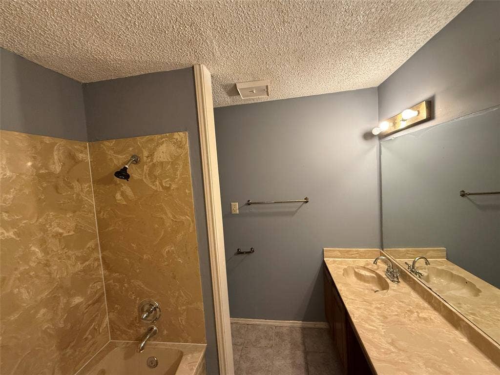 3402 Country Club Drive W, #154, Irving, TX 75038 Dual vanity with integrated sinks, full-width mirror, and a three-light fixture