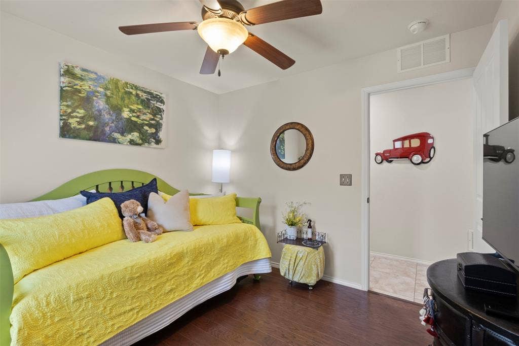 146 Montague Lane, Frisco, TX 75036 Wood-finish flooring, ceiling fan with integrated lighting, and a wall-mounted light fixture