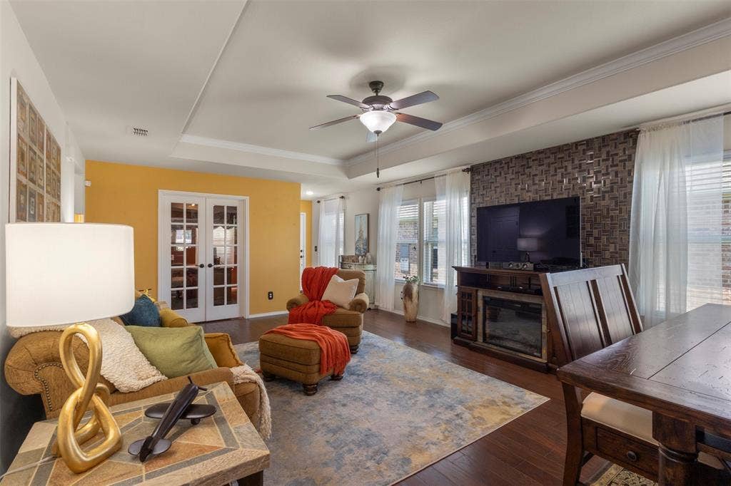 146 Montague Lane, Frisco, TX 75036 Tray ceiling with crown molding, wood-finish flooring, ceiling fan, and French doors