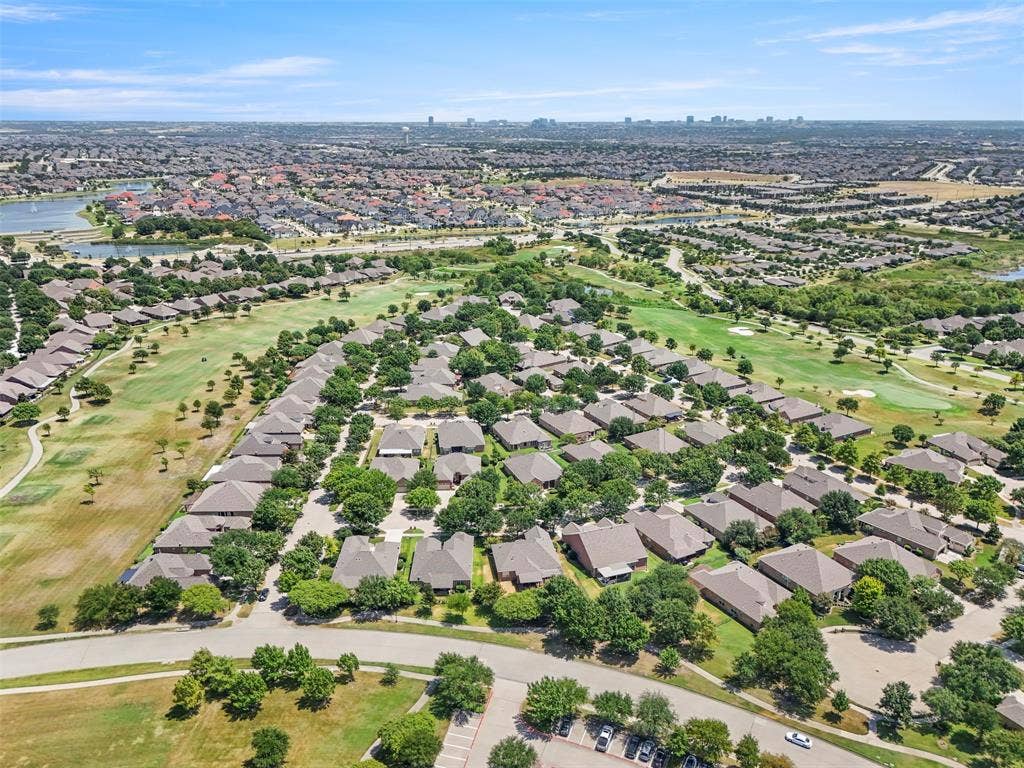 146 Montague Lane, Frisco, TX 75036 Expansive residential development with mature trees, a golf course, and a nearby body of water