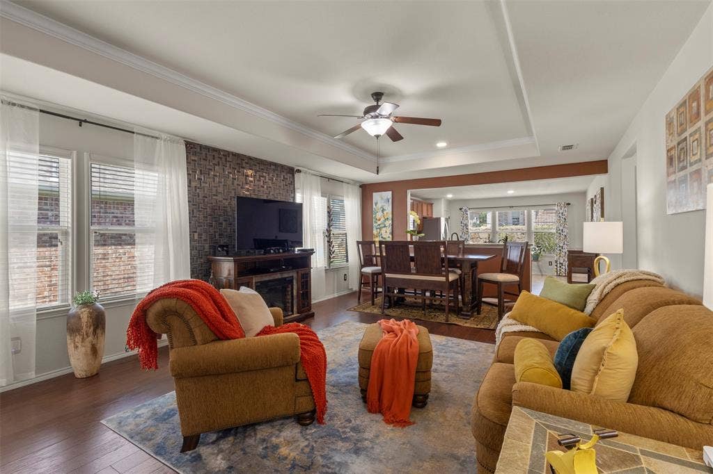 146 Montague Lane, Frisco, TX 75036 Tray ceiling with crown molding, wood-finish flooring, a decorative accent wall, recessed lighting, and a ceiling fan