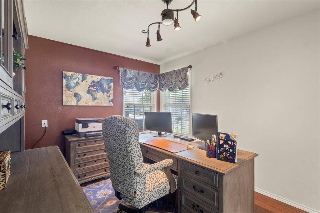 146 Montague Lane, Frisco, TX 75036 Recessed window with horizontal blinds, track lighting fixture, wood-finish flooring, and built-in cabinetry
