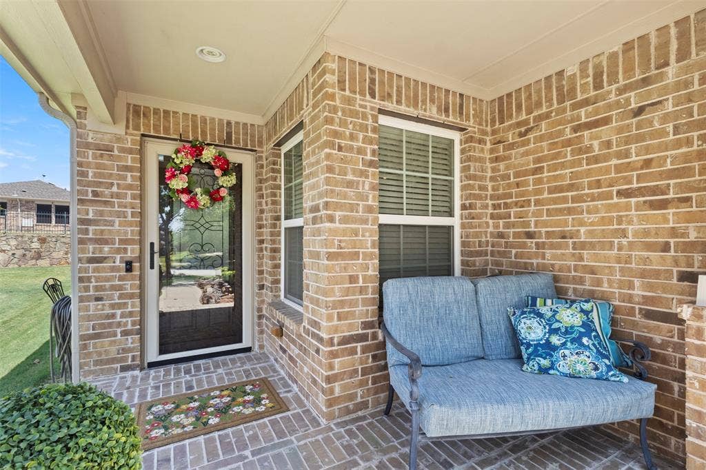 146 Montague Lane, Frisco, TX 75036 Brick exterior with a covered porch