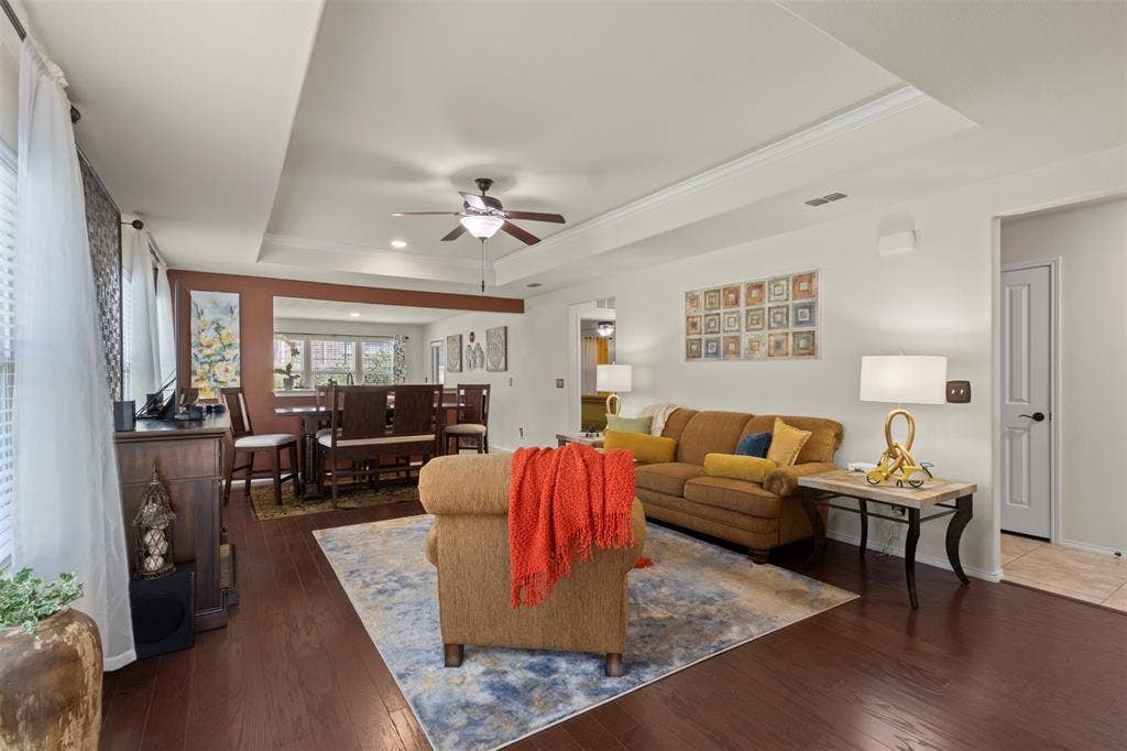 146 Montague Lane, Frisco, TX 75036 Recessed lighting, ceiling fan, rich wood-finish flooring, tray ceiling detail, and built-in window blinds