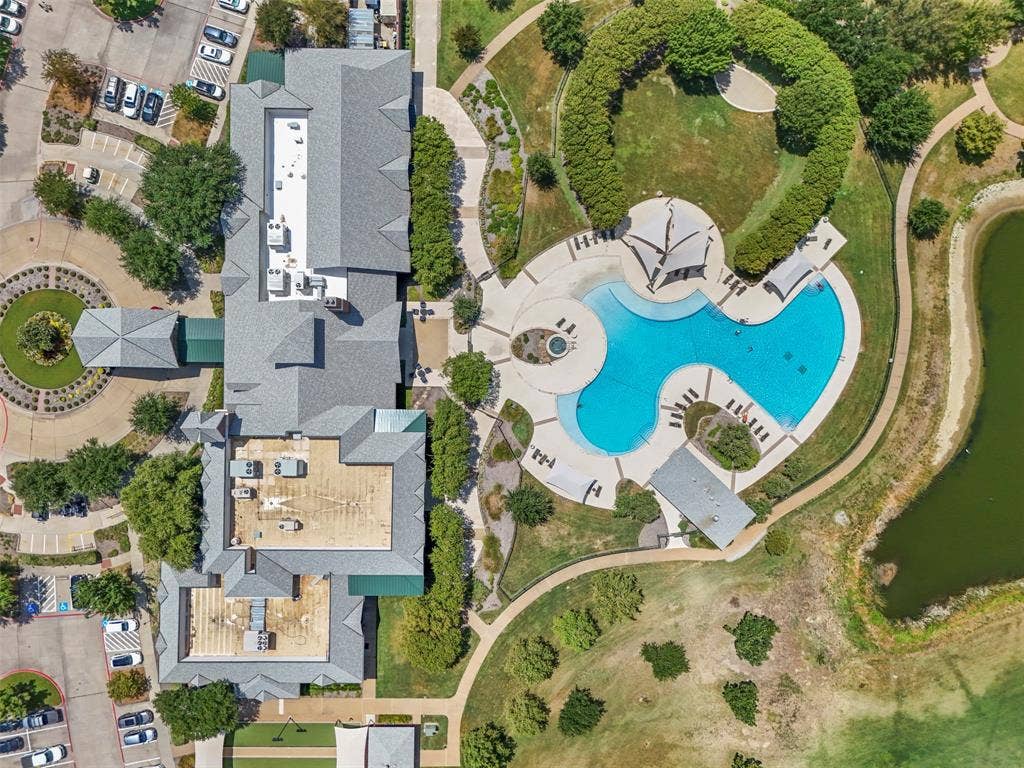 146 Montague Lane, Frisco, TX 75036 Community recreation center featuring a swimming pool, expansive paved pool deck, and shaded seating areas