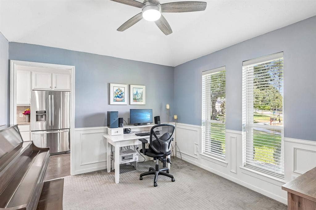 3441 Sheffield Circle, Plano, TX 75075 Bright interior space featuring a ceiling fan, dual large windows, and wainscoting