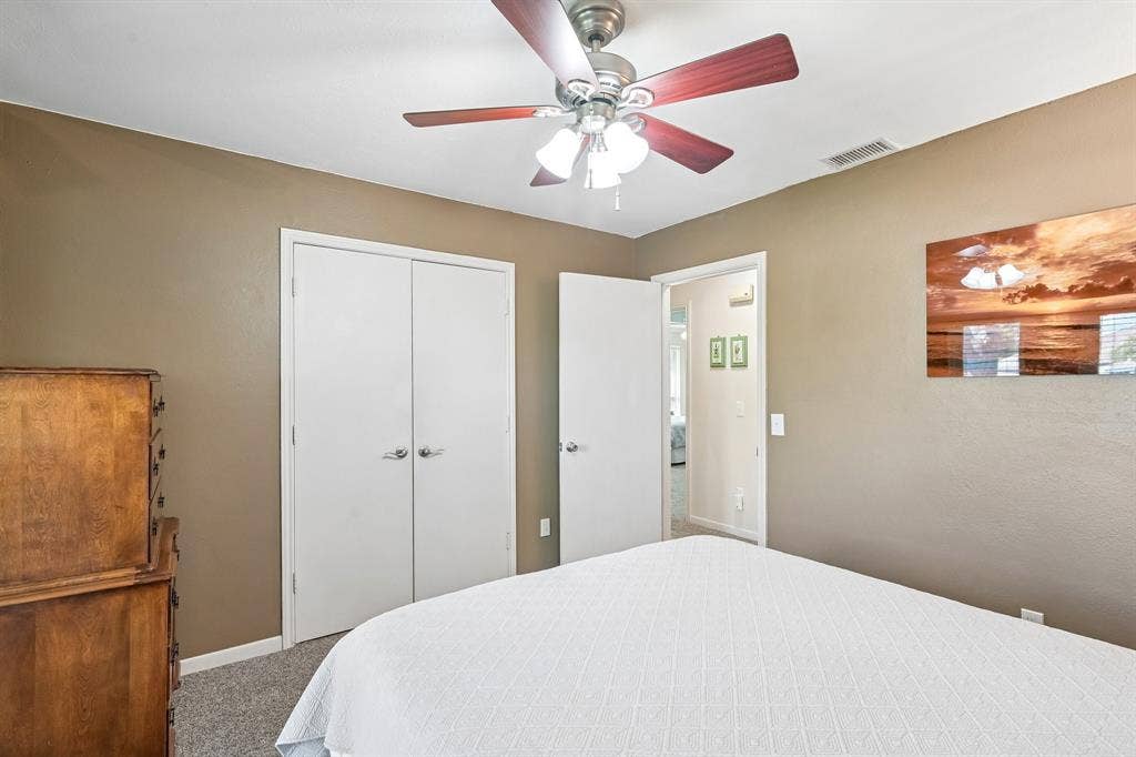 3441 Sheffield Circle, Plano, TX 75075 Ceiling fan with light fixture, neutral wall finishes, and gray carpet flooring