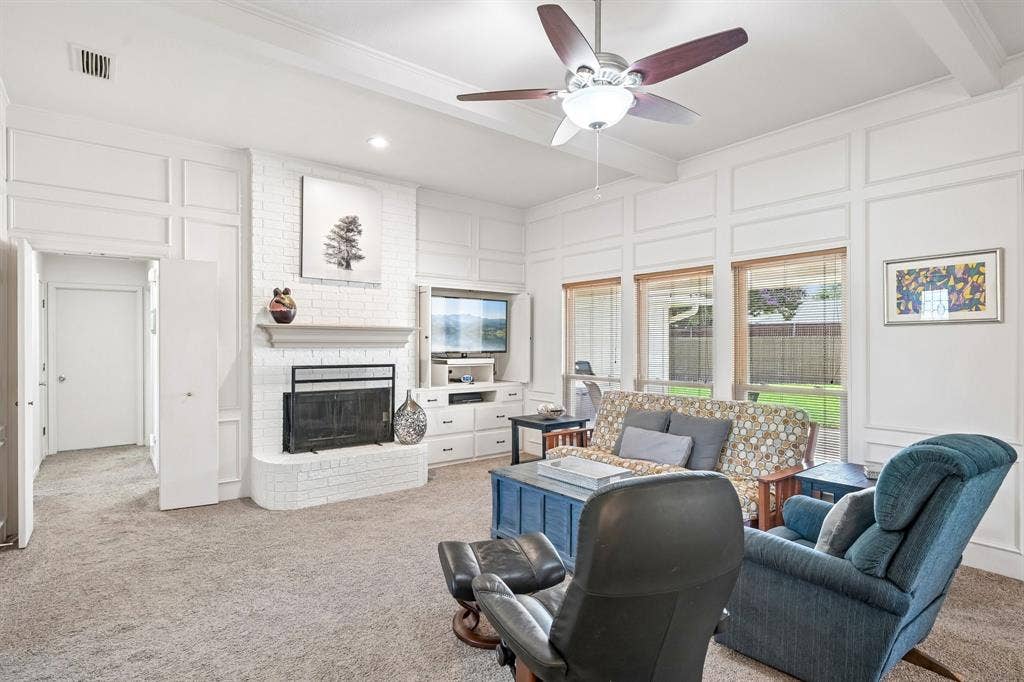 3441 Sheffield Circle, Plano, TX 75075 Living area featuring white brick fireplace, built-in entertainment console, coffered ceiling, and multiple windows