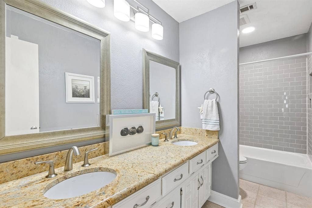 3441 Sheffield Circle, Plano, TX 75075 Dual vanity with stone-finish countertop, undermount sinks, and brushed nickel fixtures