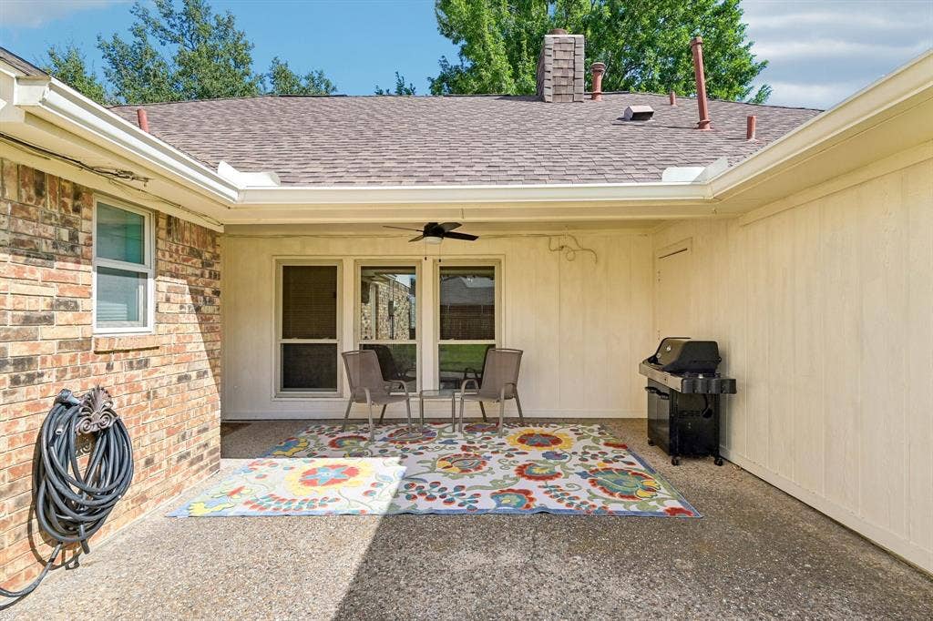 3441 Sheffield Circle, Plano, TX 75075 Covered patio featuring an outdoor ceiling fan, brick exterior, and a shingle roof