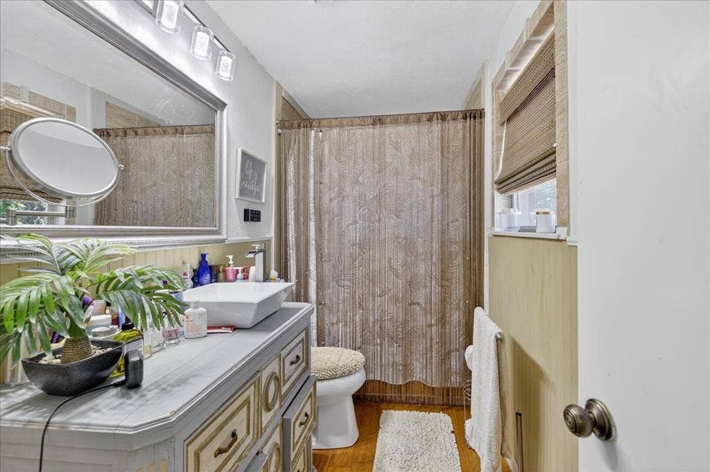 20019 Patricia Drive, Kemp, TX 75143 Primary bathroom with framed mirror, updated lighting and vanity.