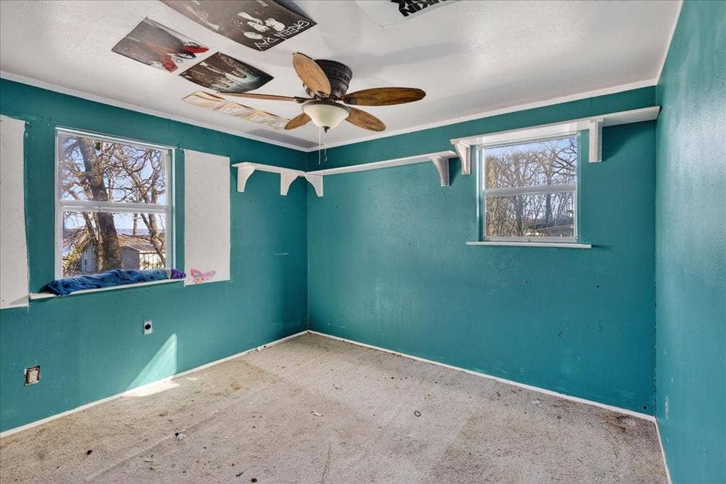20019 Patricia Drive, Kemp, TX 75143 Bedroom with ceiling fan and windows for natural lighting.