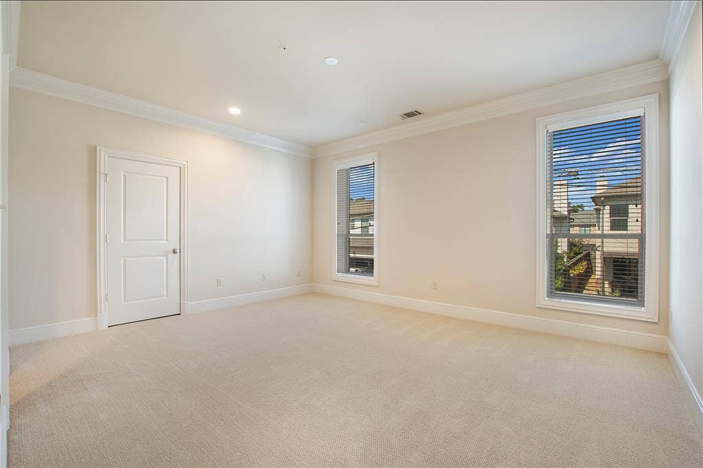 6425 Bandera Avenue, #2E, Dallas, TX 75225 Empty room with light colored carpet and a healthy amount of sunlight