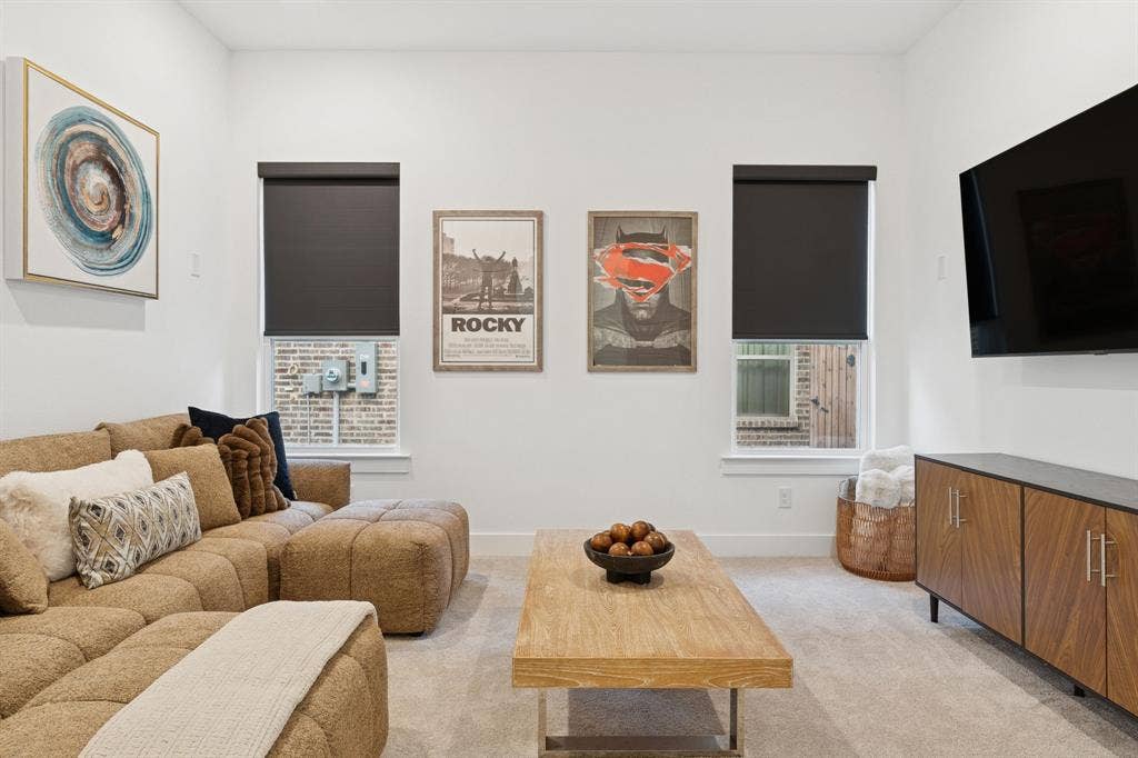 1117 Bradford Street, Celina, TX 75009 Carpeted living space featuring recessed lighting, a wall-mounted television, and a built-in media console with wood-finish cabinetry