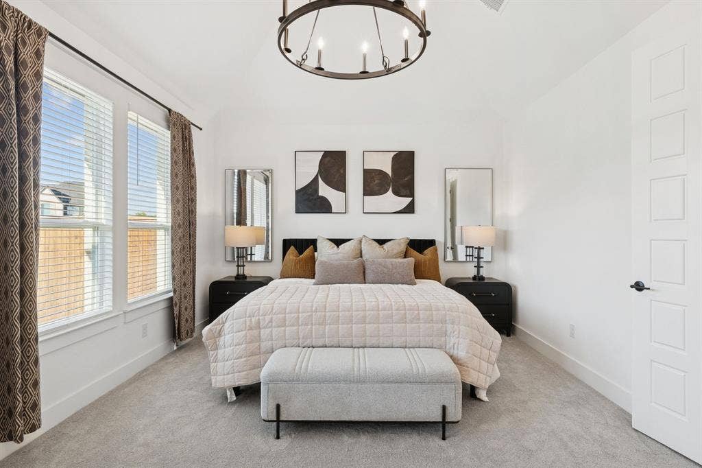 1117 Bradford Street, Celina, TX 75009 Spacious room with plush gray carpet, a high vaulted ceiling, and an industrial-style chandelier